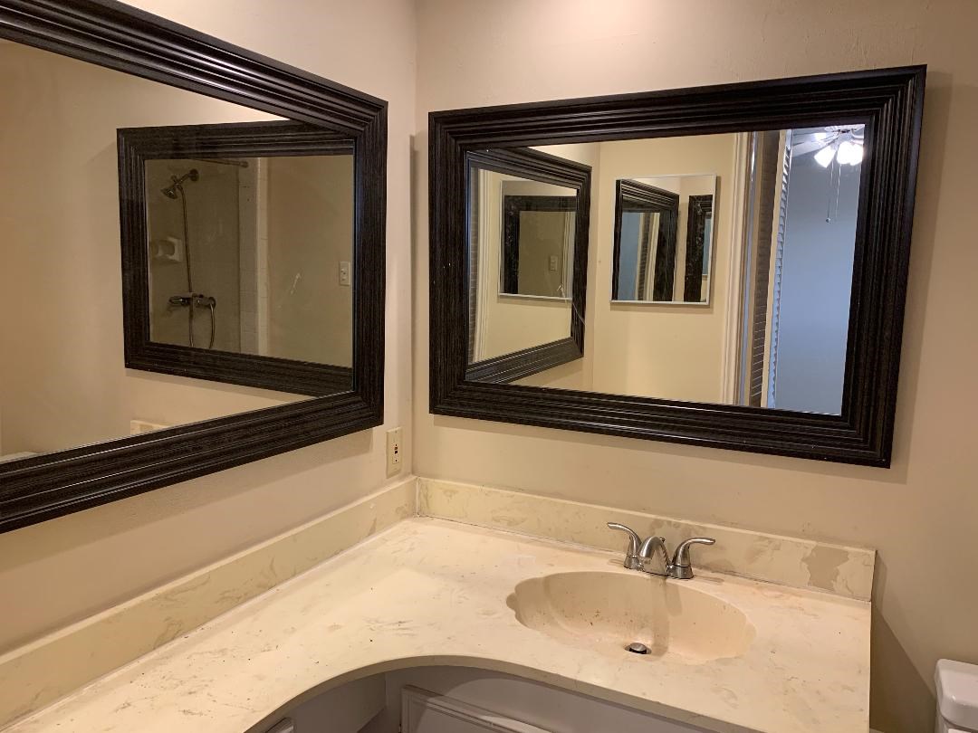 13819 Piping Rock Lane Houston, TX 77077 - Photo 11 of 16 a bathroom with a sink and a mirror