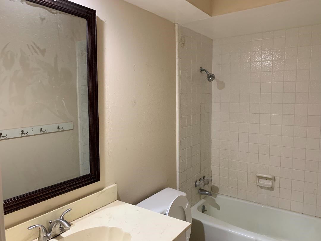 13819 Piping Rock Lane Houston, TX 77077 - Photo 14 of 16 a bathroom with a sink and a bathtub