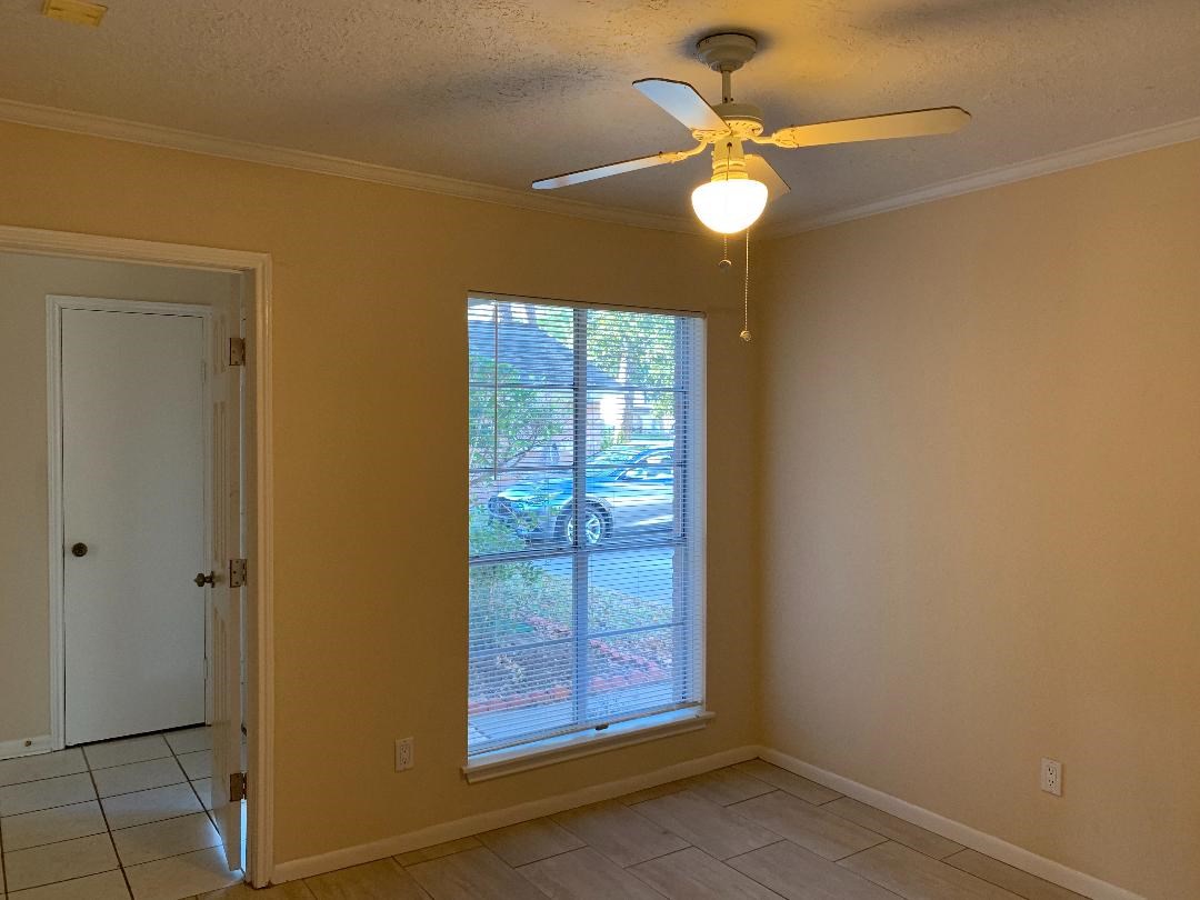 13819 Piping Rock Lane Houston, TX 77077 - Photo 4 of 16 a view of an empty room with a window