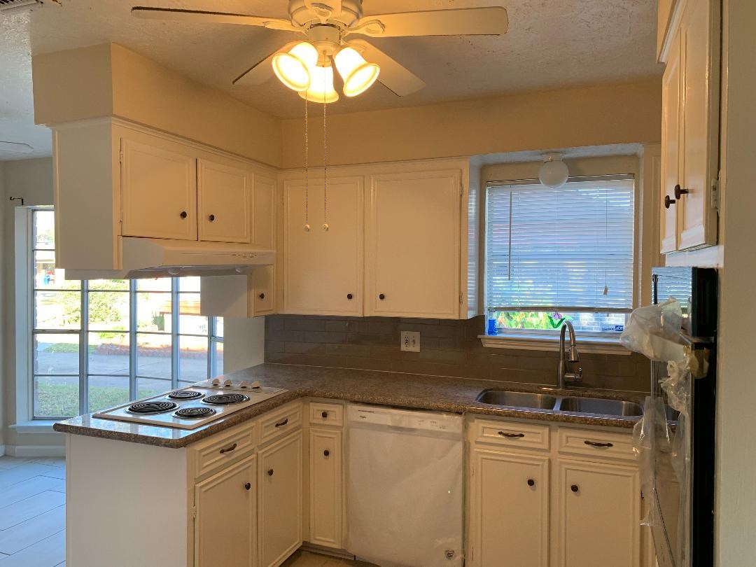 13819 Piping Rock Lane Houston, TX 77077 - Photo 5 of 16 a kitchen with stainless steel appliances granite countertop a sink a stove and cabinets