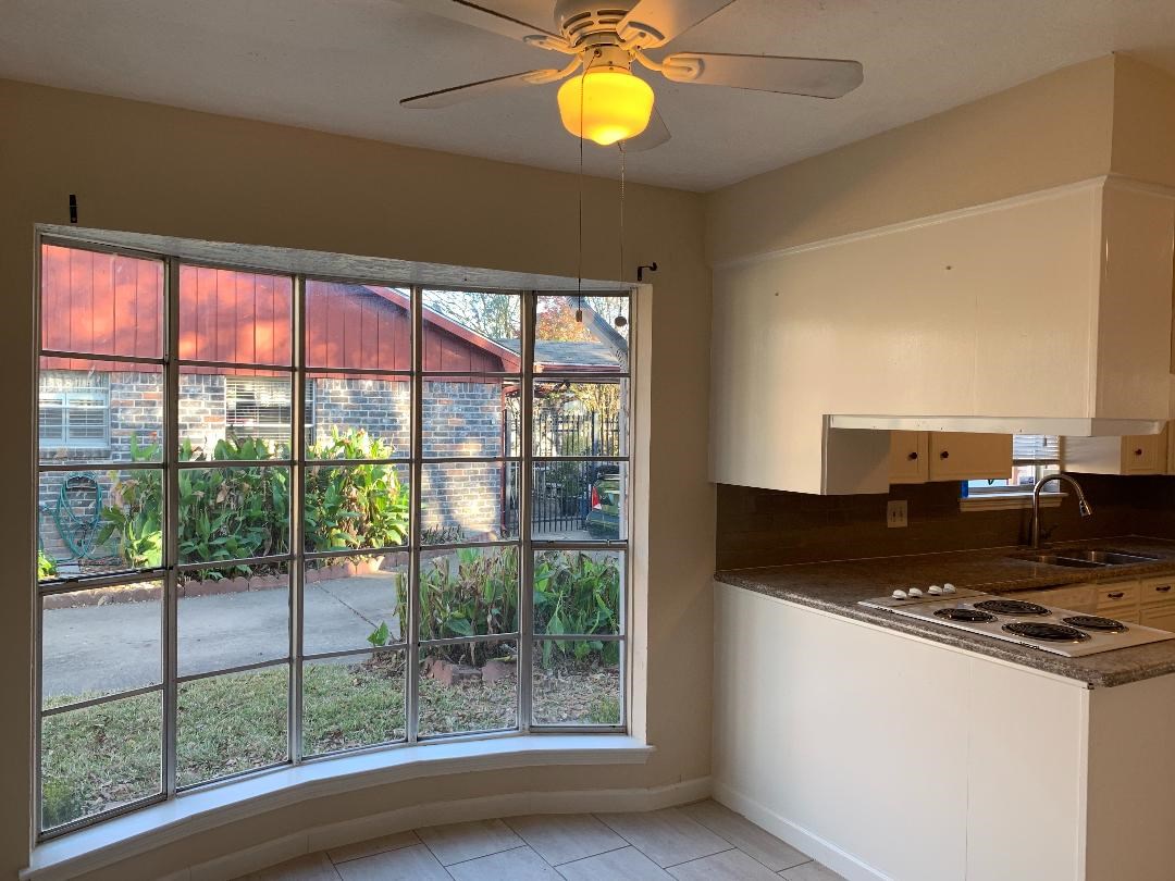 13819 Piping Rock Lane Houston, TX 77077 - Photo 6 of 16 a kitchen with a stove and a window