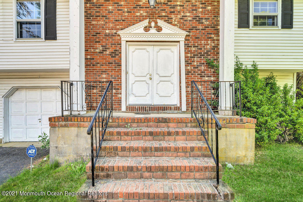 60 Charles Drive Tinton Falls, NJ 07753 - Photo 2 of 23 a front view of a house with a garden
