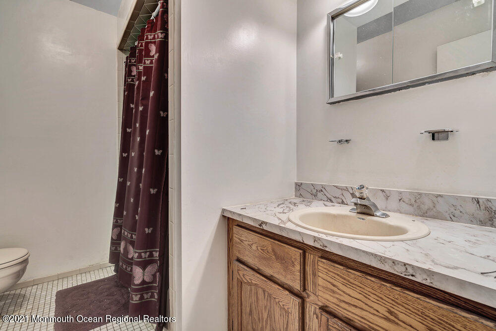 60 Charles Drive Tinton Falls, NJ 07753 - Photo 11 of 23 a bathroom with a sink and a mirror