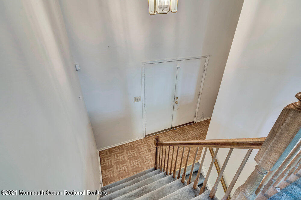 60 Charles Drive Tinton Falls, NJ 07753 - Photo 17 of 23 a view of staircase with railing and white walls
