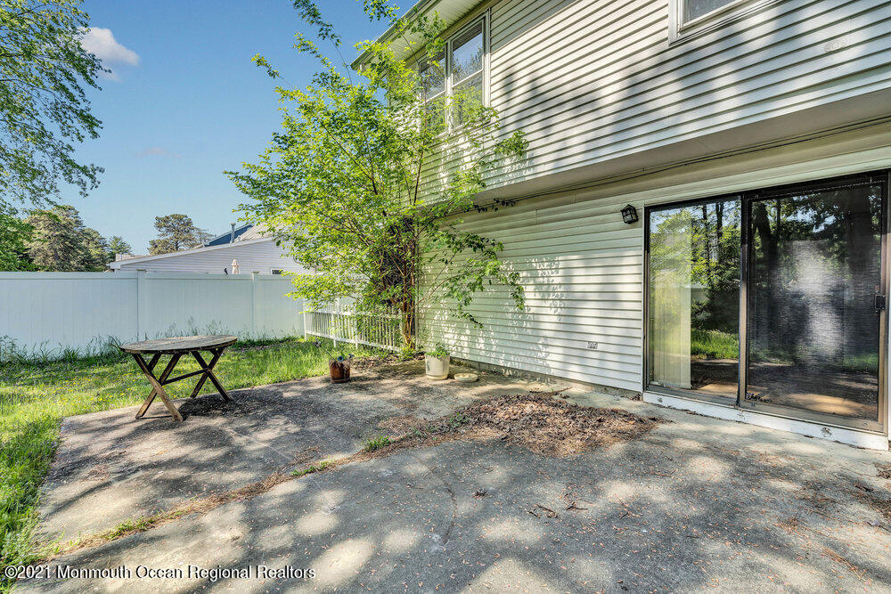 60 Charles Drive Tinton Falls, NJ 07753 - Photo 19 of 23 a view of backyard with table and chairs and large trees