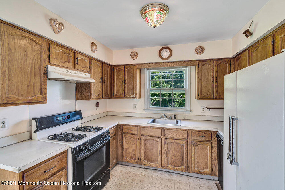 60 Charles Drive Tinton Falls, NJ 07753 - Photo 3 of 23 a kitchen with a stove a sink and a refrigerator