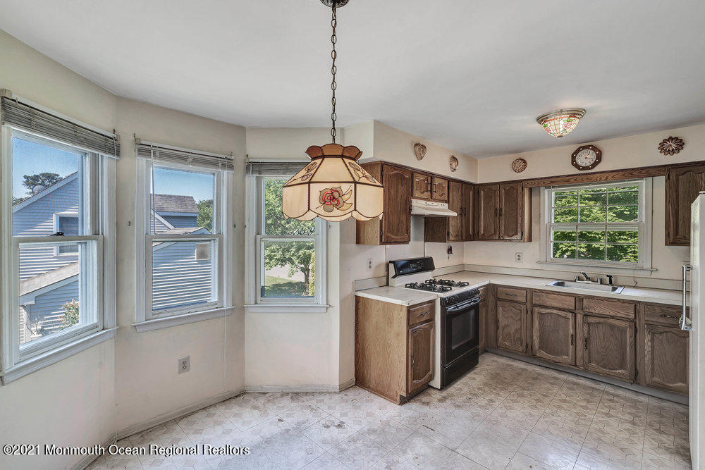 60 Charles Drive Tinton Falls, NJ 07753 - Photo 4 of 23 a kitchen with a stove a sink and a window