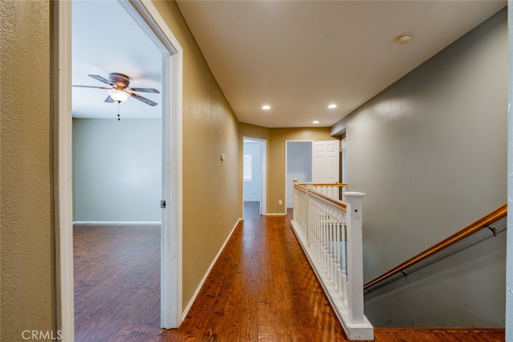 6349 Catania Court Palmdale, CA 93552 - Photo 17 of 36 a view of a hallway with wooden floor and staircase