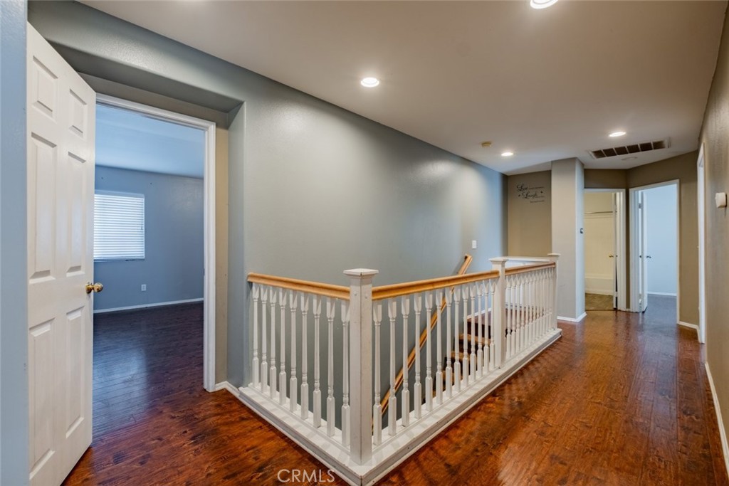 6349 Catania Court Palmdale, CA 93552 - Photo 18 of 36 a view of a hallway with wooden floor