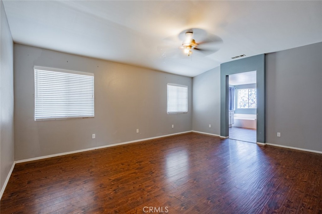 6349 Catania Court Palmdale, CA 93552 - Photo 19 of 36 a view of an empty room with wooden floor and a window