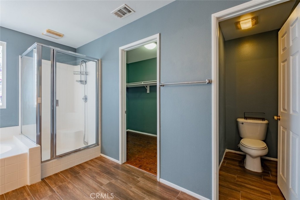 6349 Catania Court Palmdale, CA 93552 - Photo 23 of 36 a bathroom with a shower and a toilet