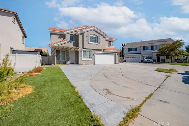 a view of house with yard and car parked