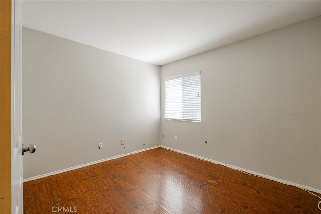 6349 Catania Court Palmdale, CA 93552 - Photo 32 of 36 a view of a room with wooden floor and window