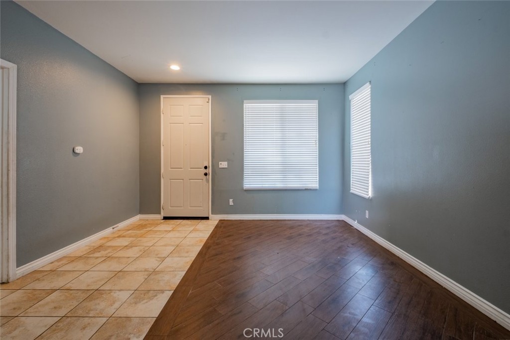 6349 Catania Court Palmdale, CA 93552 - Photo 4 of 36 an empty room with wooden floor and windows