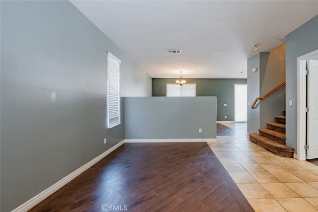 a view of a livingroom with wooden floor and a fireplace