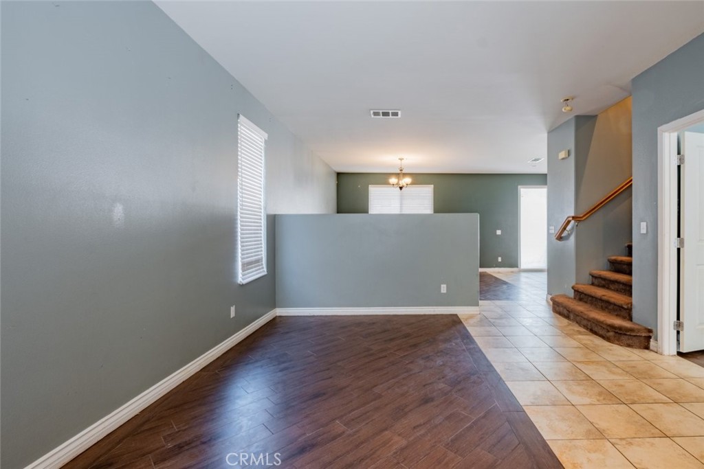6349 Catania Court Palmdale, CA 93552 - Photo 5 of 36 a view of a livingroom with wooden floor and a fireplace