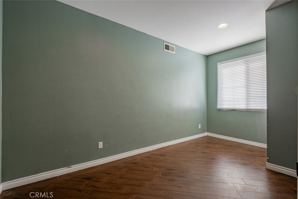 6349 Catania Court Palmdale, CA 93552 - Photo 7 of 36 an empty room with wooden floor and windows