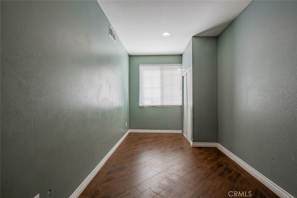 6349 Catania Court Palmdale, CA 93552 - Photo 8 of 36 an empty room with wooden floor and windows