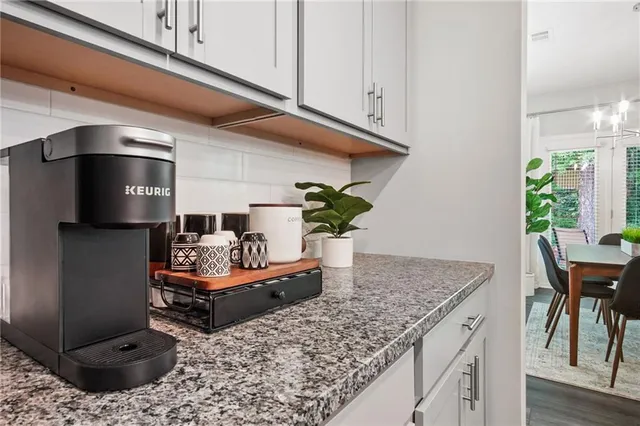 a living room with kitchen island furniture and a potted plant