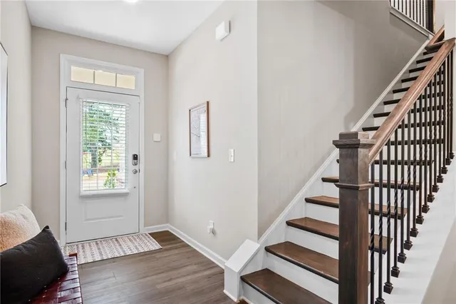 a view of an entryway with wooden floor and stairs