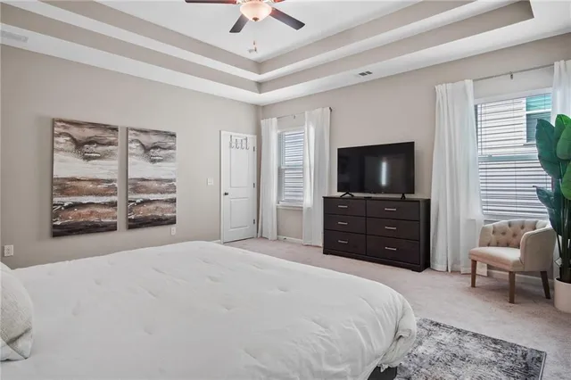 a bedroom with a bed and a television