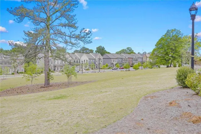a view of swimming pool with outdoor seating and house in the background