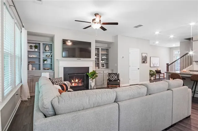 a living room with furniture fireplace and a flat screen tv