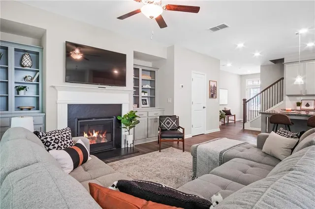 a living room with furniture fireplace and flat screen tv
