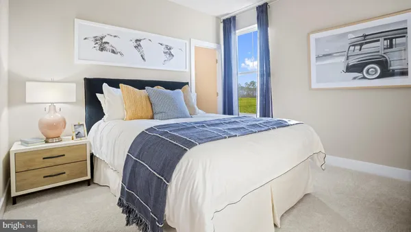 a bedroom with a bed and a night stand