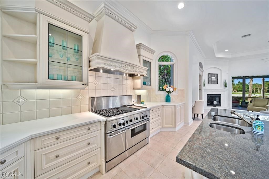 2402 Wulfert Road Sanibel, FL 33957 - Photo 15 of 47 a kitchen with granite countertop a stove a sink and wooden floors