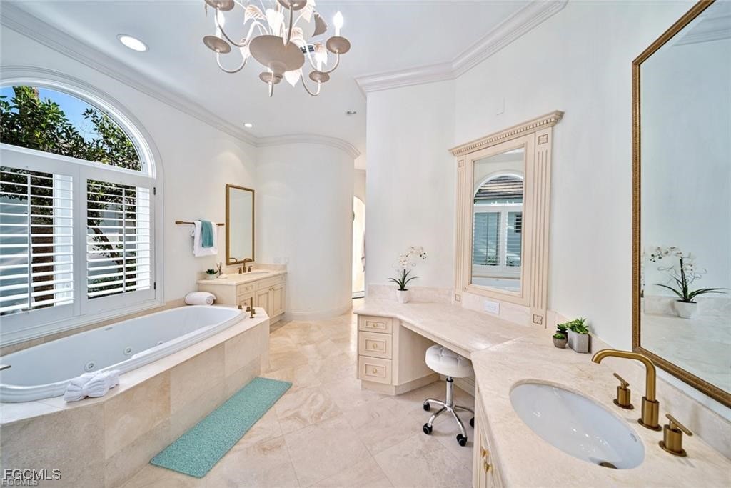 2402 Wulfert Road Sanibel, FL 33957 - Photo 22 of 47 a bathroom with a tub double vanity sink and a mirror