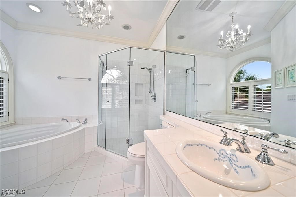 2402 Wulfert Road Sanibel, FL 33957 - Photo 30 of 47 a spacious bathroom with a sink a large mirror and a bathtub