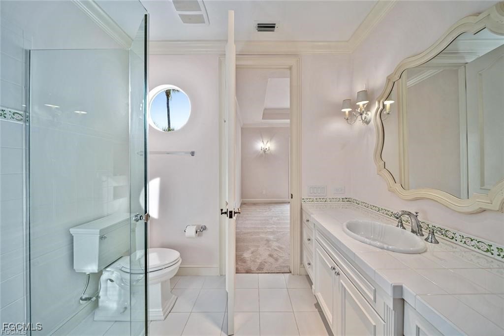 2402 Wulfert Road Sanibel, FL 33957 - Photo 31 of 47 a bathroom with a sink a toilet and shower