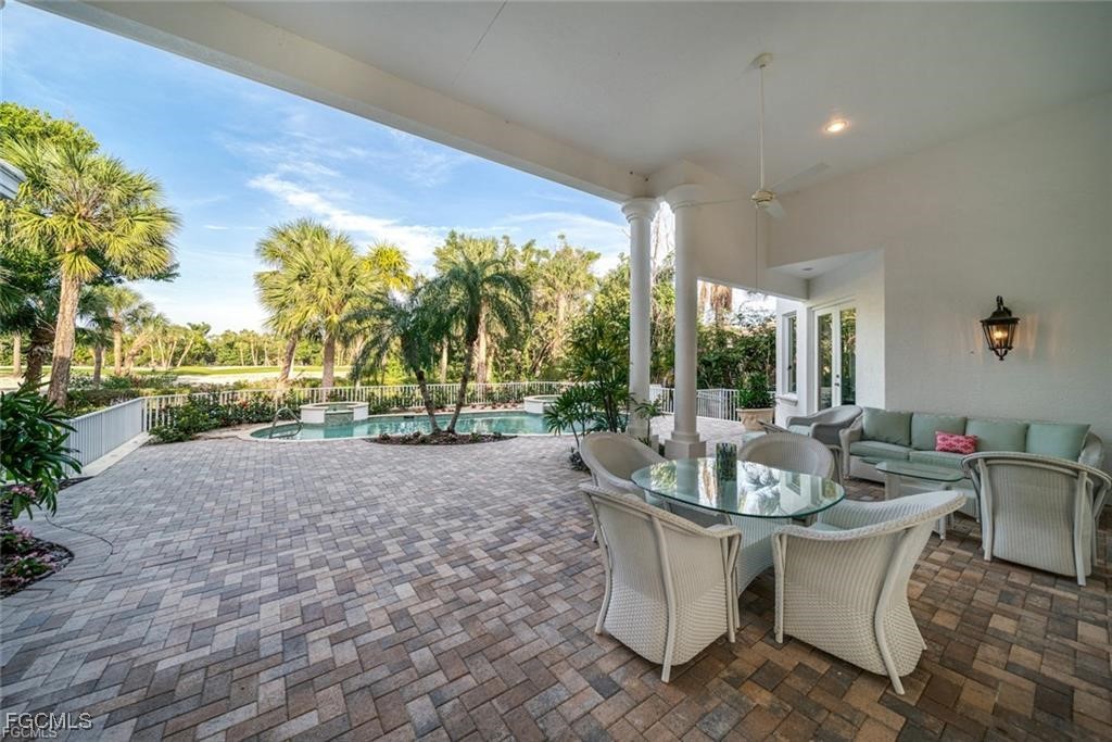 2402 Wulfert Road Sanibel, FL 33957 - Photo 45 of 47 a view of a patio with couches and table and chairs and potted plants