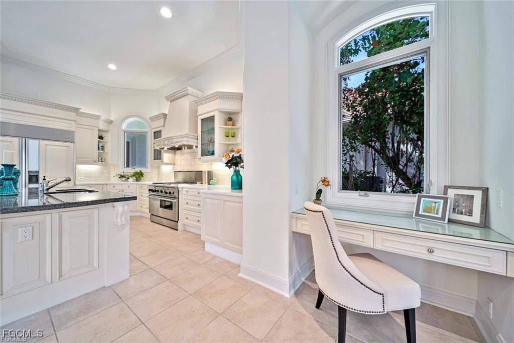 2402 Wulfert Road Sanibel, FL 33957 - Photo 46 of 47 a kitchen with white cabinets and window