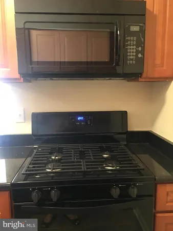 a stove top oven sitting inside of a kitchen