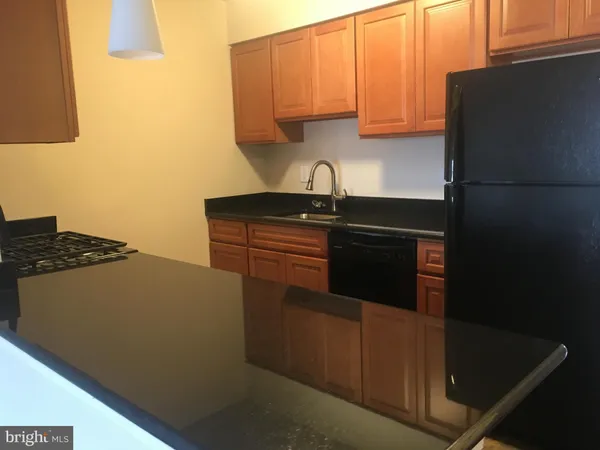 a kitchen with a sink and a refrigerator
