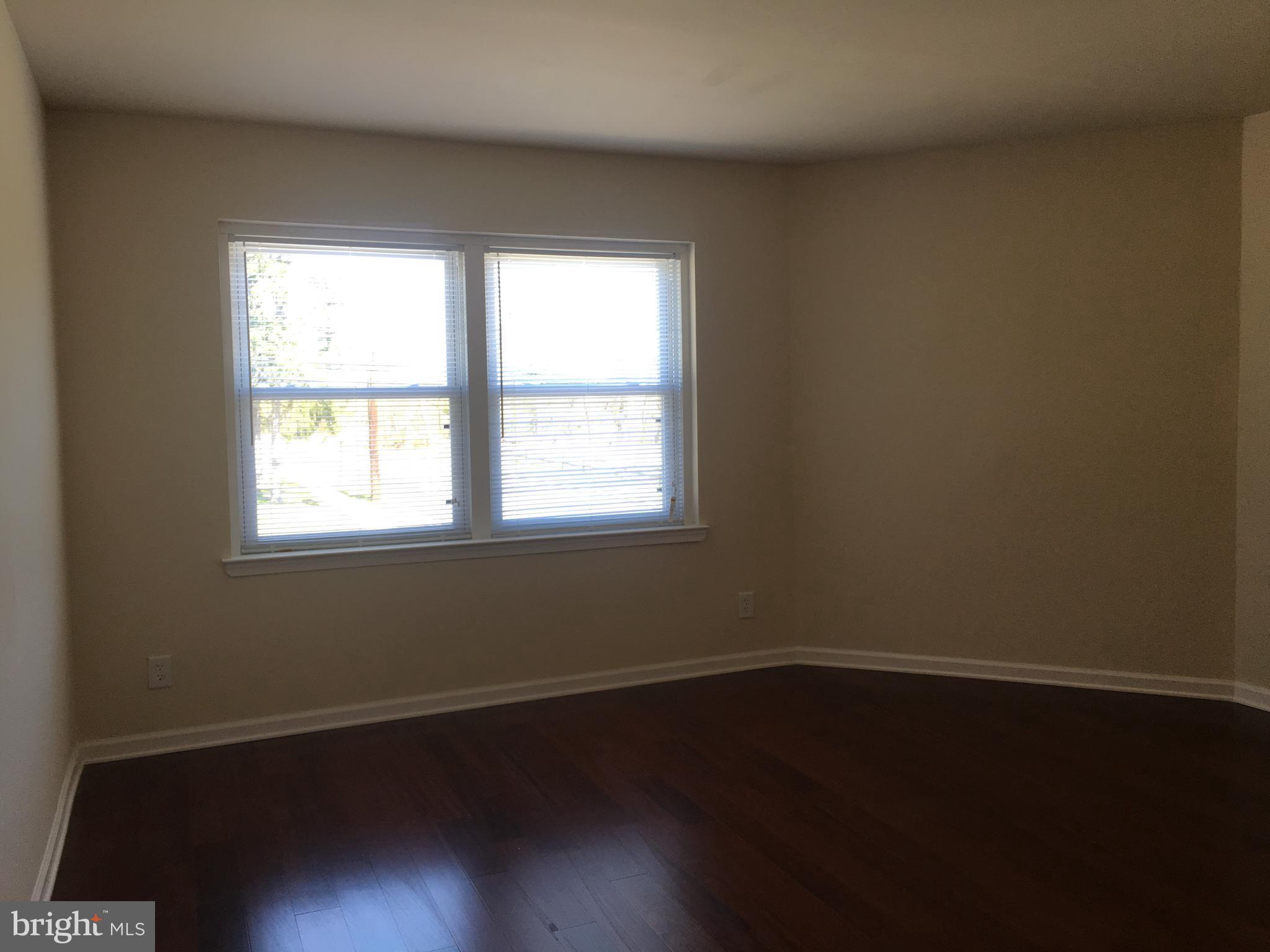 1 Pennsylvania Road, Unit 4 Glassboro, NJ 08028 - Photo 3 of 37 an empty room with wooden floor and windows