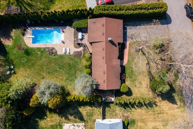 a view of a swimming pool with chair and table in the garden
