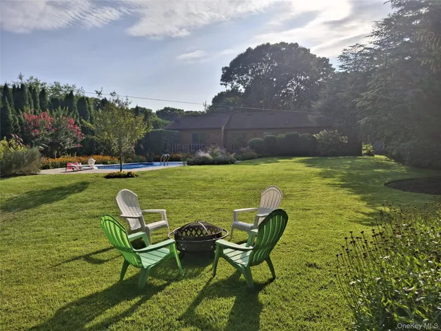 a view of a house with swimming pool and a yard