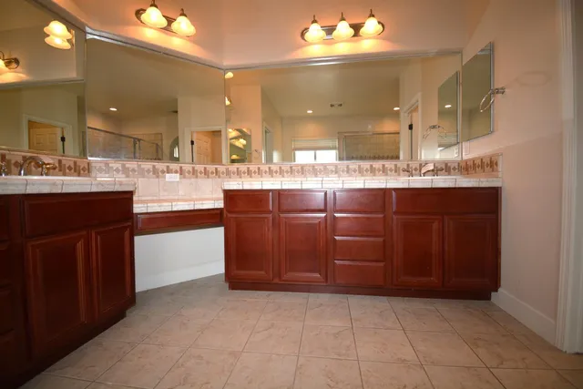 a bathroom with a sink double vanity and a mirror