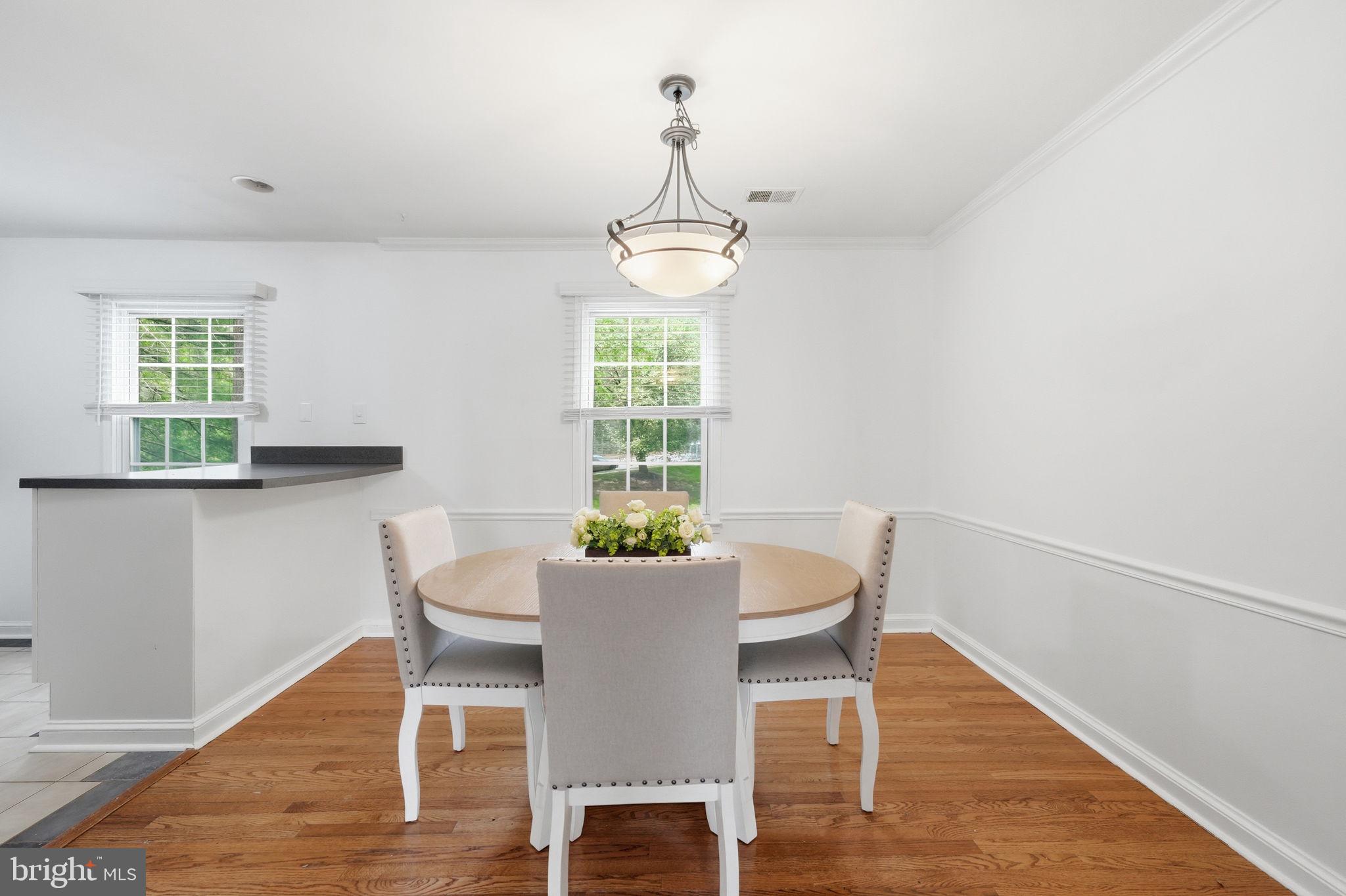 8260 Getty Court Springfield, VA 22153 - Photo 8 of 31 a view of a dining room with furniture window and wooden floor