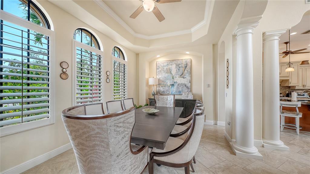 1630 Assisi Drive, Unit 18 Sarasota, FL 34231 - Photo 9 of 42 a dining room with furniture and a window