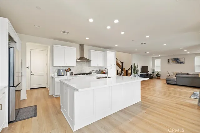 a bathroom with a granite countertop sink and a mirror with toilet