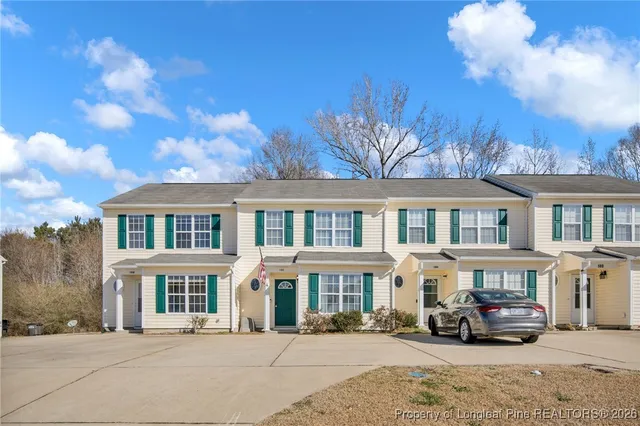 a car parked in front of a brick house