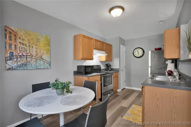 a kitchen with sink cabinets and dining table