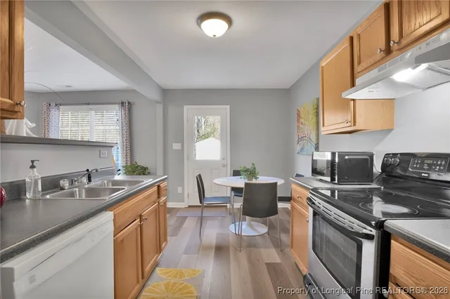 a kitchen with a sink stove and cabinets