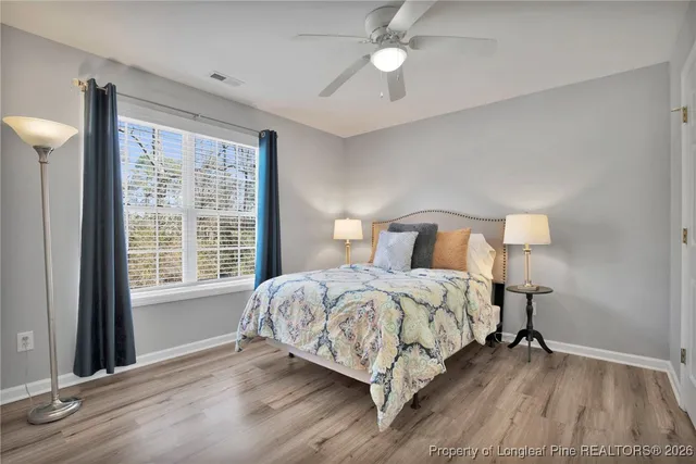 a bedroom with a bed lamp and a window