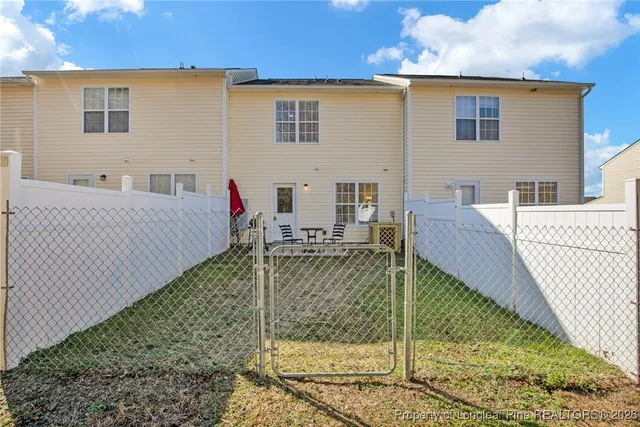 a view of house with backyard