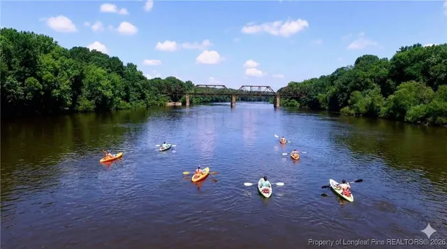 an aerial view of a house with outdoor space and lake view